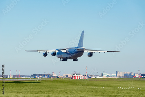 Landing of the big cargo airliner in the airport.