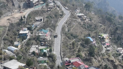 Aerial top view of traffic vehicles driving at mountains roads at Nainital, Uttarakhand, India, View from the top side of mountain for movement of traffic vehicles photo