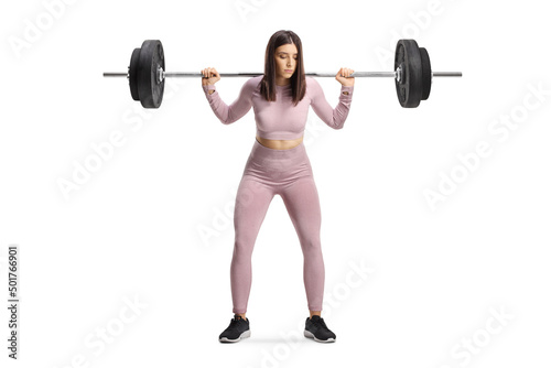 Sporty female standing and lifting heavy weights