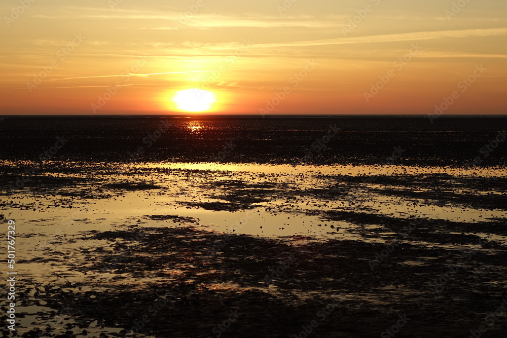 Beautiful sunset over the North Sea wadden seas at low tide, spring evening (horizontal), Sahlenburg, Lower Saxony, Germany