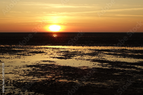 Beautiful sunset over the North Sea wadden seas at low tide  spring evening  horizontal   Sahlenburg  Lower Saxony  Germany