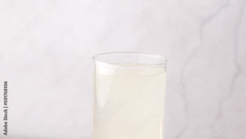 dropping Effervescent soluble tablet pills in a glass of water dropping Effervescent soluble tablet pills in a glass of water