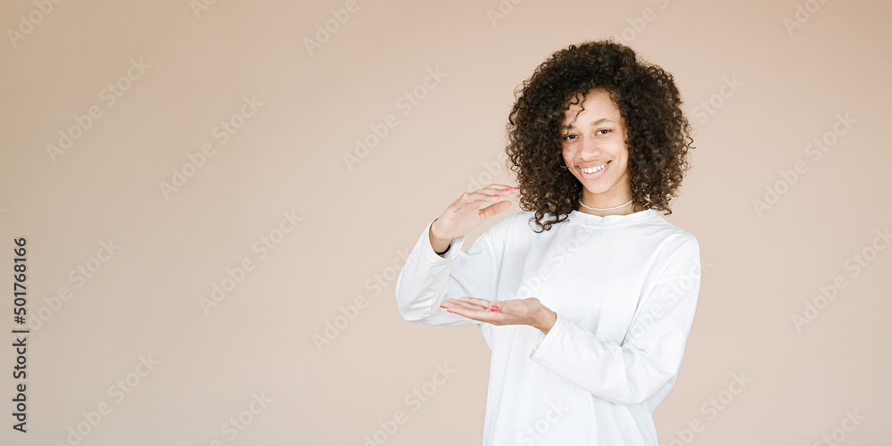 Young African american girl wearing over brown background gesturing with hands showing big and large size sign, measure symbol. Smiling looking at the camera. Measuring Young African american girl wearing over brown background gesturing with hands showing big and large size sign, measure symbol. Smiling looking at the camera. Measuring