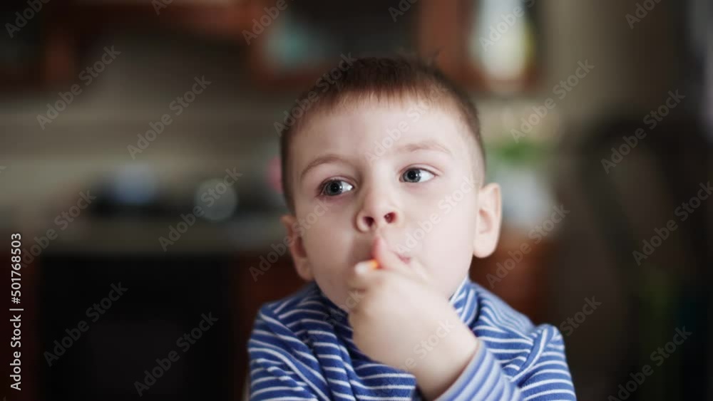 Child boy eating a small donut Child boy eating a small donut