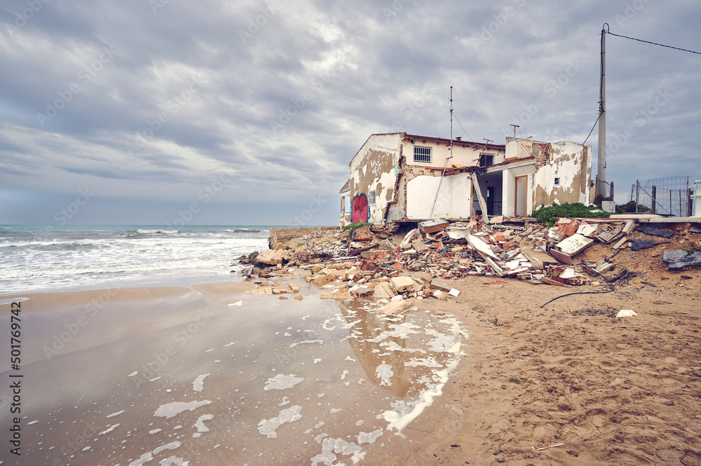 Devastation concept. Waves of high tide created by a tsunami destroys