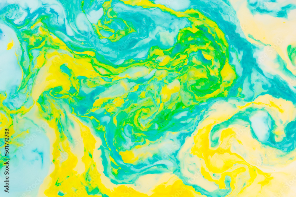 Fluid art creative background. Turquoise yellow spots on liquid. Abstract background with multi-colored stains. Chaos concept