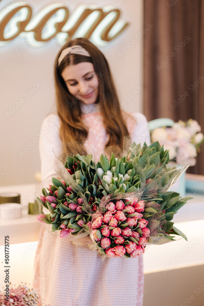 Woman make spring bouquet. Female florist hold bouquet of spring flowers. Beautiful flower composition. Fresh tulips Woman make spring bouquet. Female florist hold bouquet of spring flowers. Beautiful flower composition. Fresh tulips