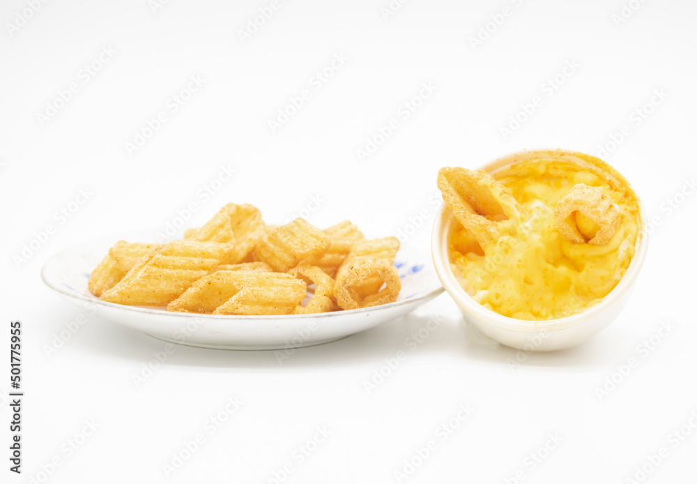 corn chips in a plate with white souce isolated on white background, selective focus corn chips in a plate with white souce isolated on white background, selective focus