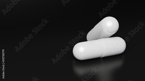 Two white smooth pills lie on a black background. One pill lies on the other.