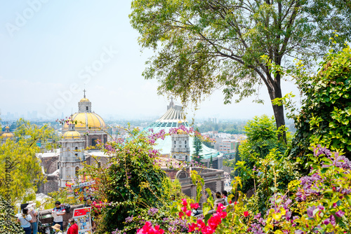 Tableau sur toile Mexico City, Mexico; april 24 2022: ancient and modern guadalupe basilica behind trees and flowers