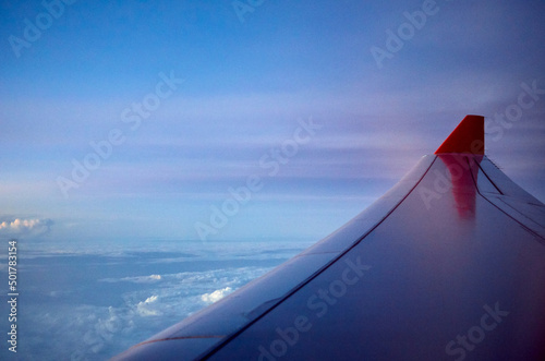 airplane wing in the sky. blue sky and white clouds