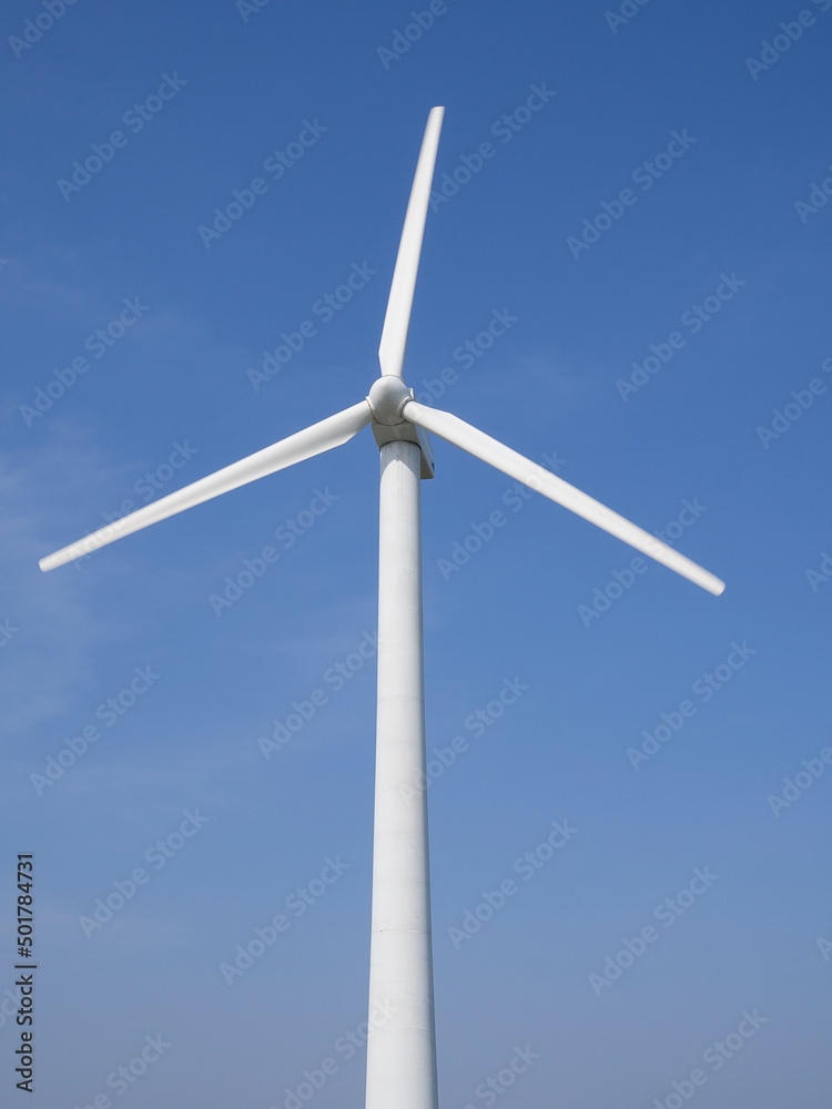 Alternative energy. Wind generator turbines generating electricity on blue sky background. Alternative energy. Wind generator turbines generating electricity on blue sky background.