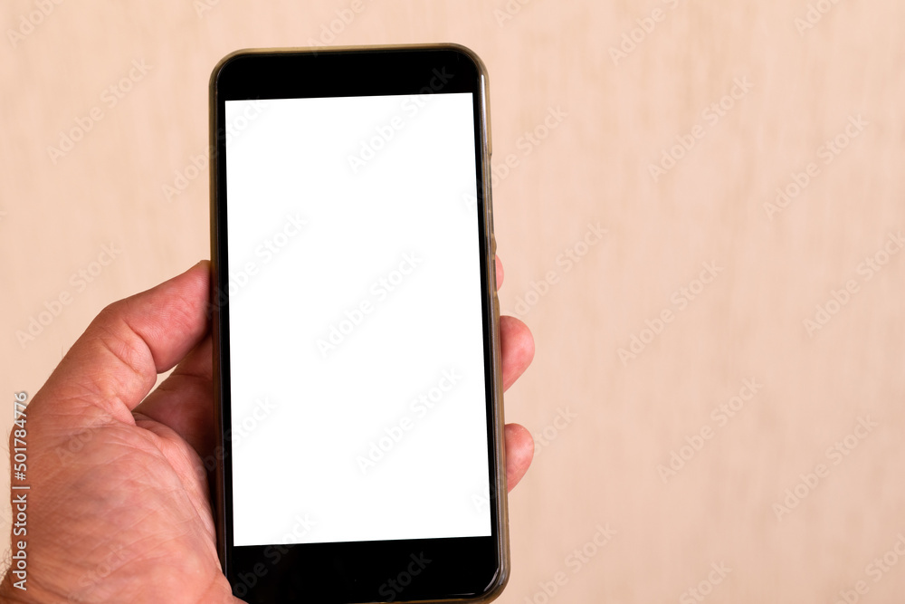 hand holding cellphone with white screen and blurred background hand holding cellphone with white screen and blurred background