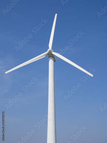 Alternative energy. Wind generator turbines generating electricity on blue sky background.