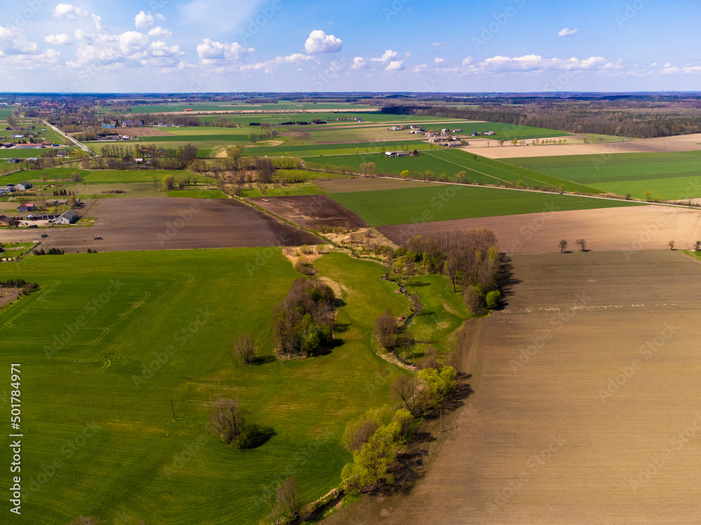 Naklejka premium Spring fields, meadows and villages seen from a bird's eye view on a sunny, clear day. Spring.