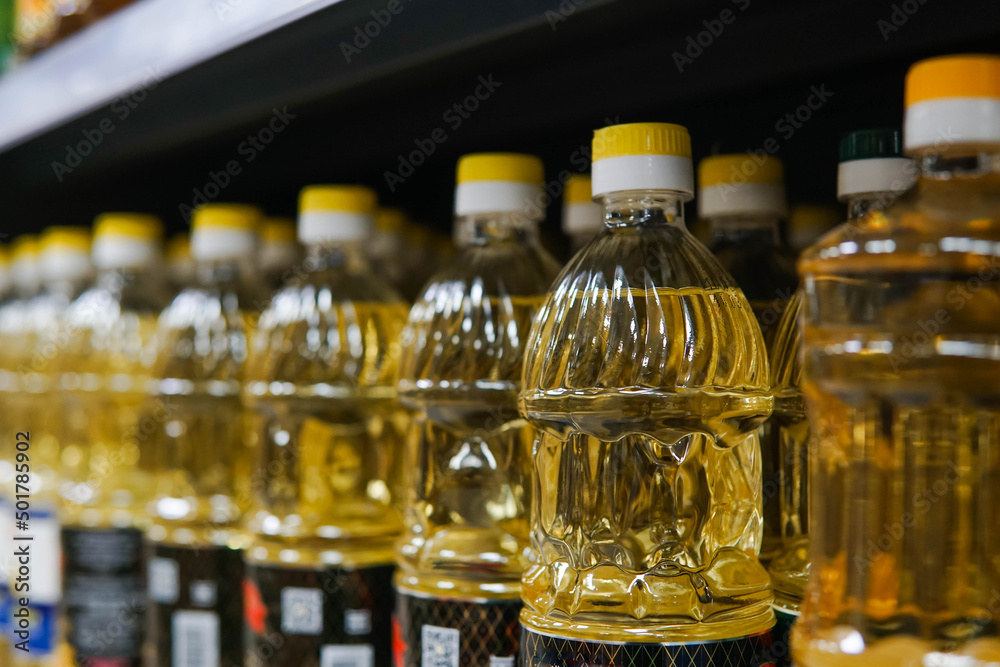 A lot of yellow sunflower oil bottles on the shelves in the supermarket. Sunflower oil shortage crisis in Europe. A lot of yellow sunflower oil bottles on the shelves in the supermarket. Sunflower oil shortage crisis in Europe.