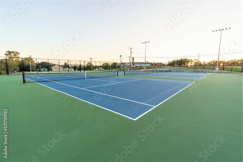 Late afternoon photo of blue tennis courts © Thomas