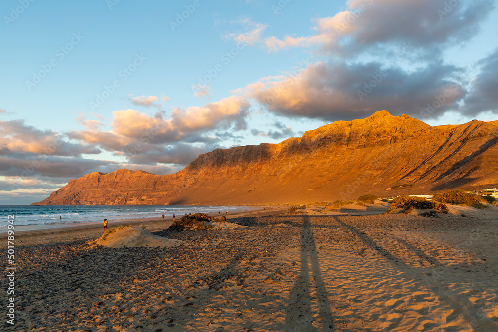 Famara beach and Risco de Famara mountains at sunset, Spain