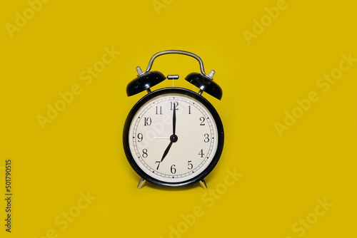 Clock alarm clock on a bright yellow background