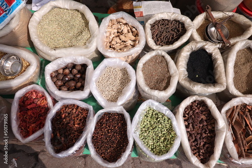 Vendor selling different types of spices at a market