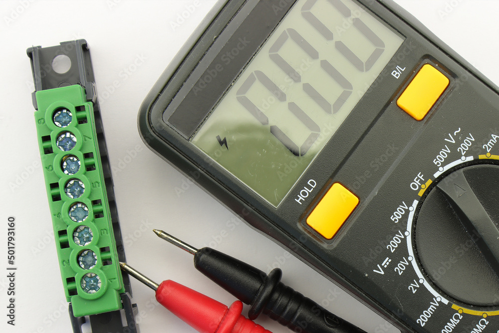 Multimeter and tools for electrical installation in a close-up schematic diagram.