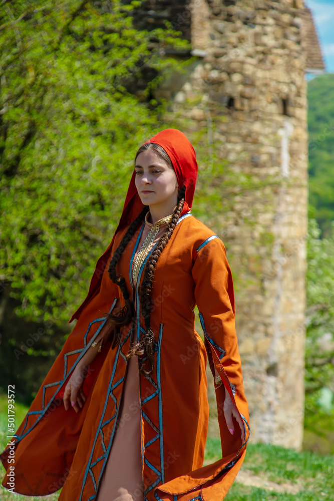 Georgian girl in national costume dances Georgian national dances. selective focus Georgian girl in national costume dances Georgian national dances. selective focus