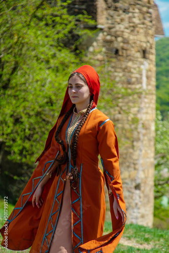 Georgian girl in national costume dances Georgian national dances. selective focus