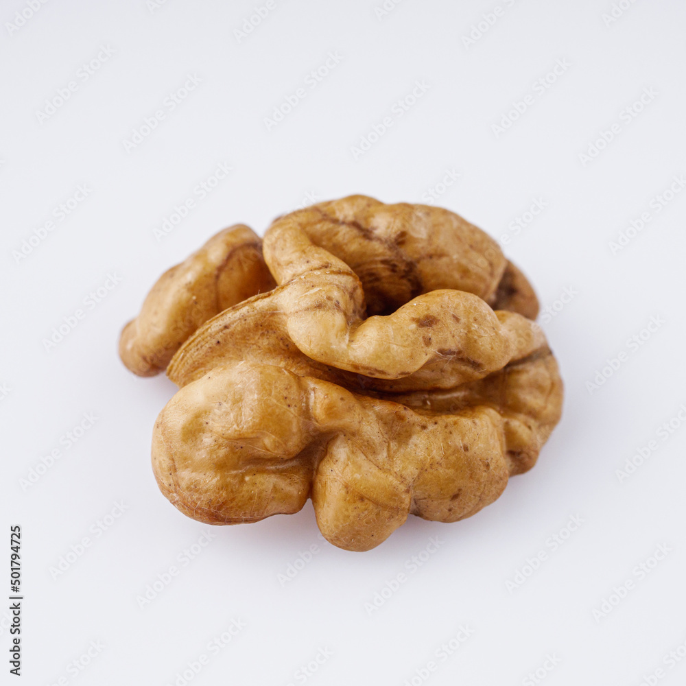 dried walnuts on a white acrylic background dried walnuts on a white acrylic background