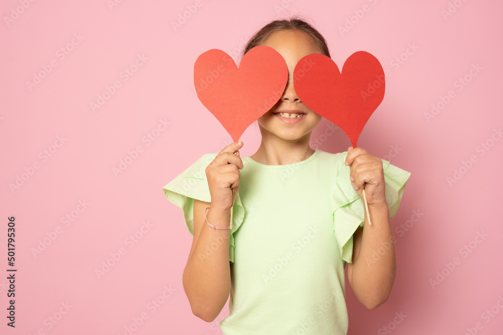love, happiness and people concept - smiling little girl with red hearts