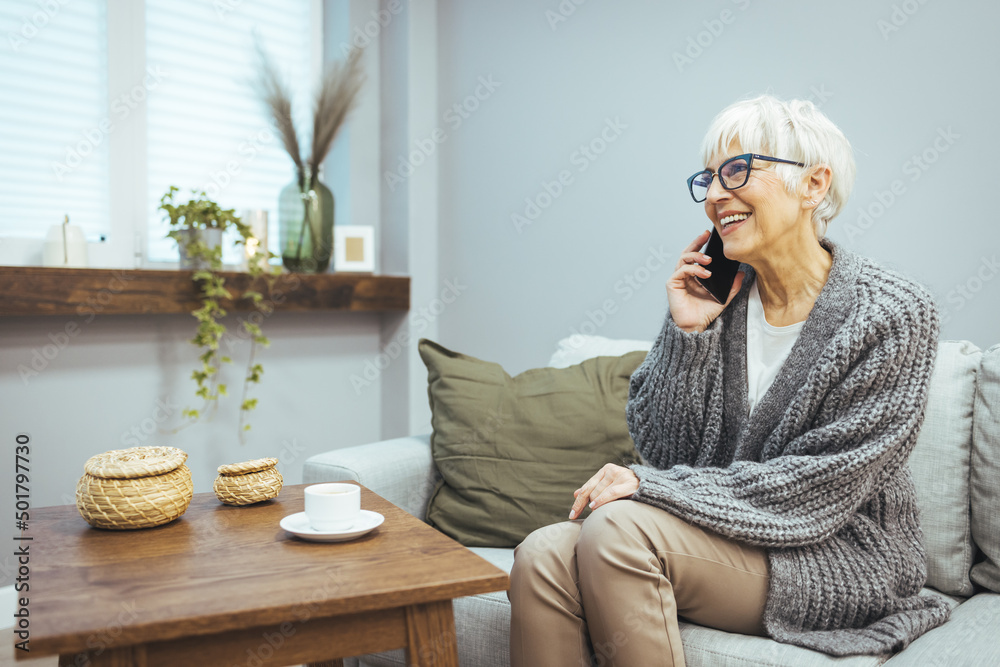 A smiling mature woman is talking on the phone. Mature woman in conversation using cellphone while laughing. A young cheerful lady is having fun during a fun conversation. A smiling mature woman is talking on the phone. Mature woman in conversation using cellphone while laughing. A young cheerful lady is having fun during a fun conversation.
