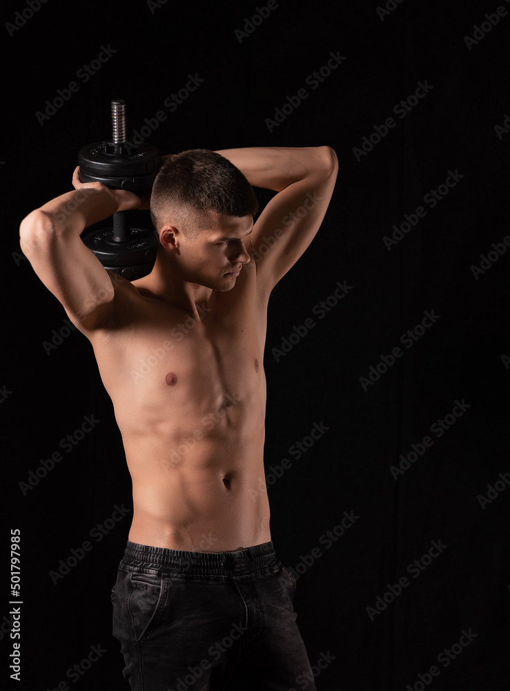 strong sexy man with dumbbells on a black background strong sexy man with dumbbells on a black background