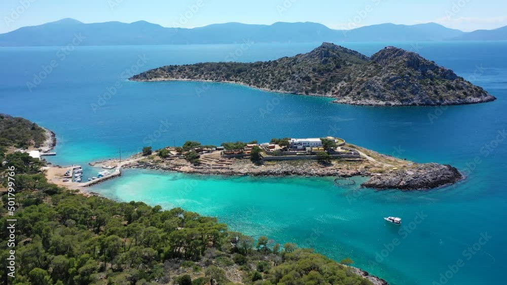Aerial drone video of iconic Aponisos bay and lake with clear turquoise sea and pine trees, Agistri island, Saronic gulf, Greece Aerial drone video of iconic Aponisos bay and lake with clear turquoise sea and pine trees, Agistri island, Saronic gulf, Greece