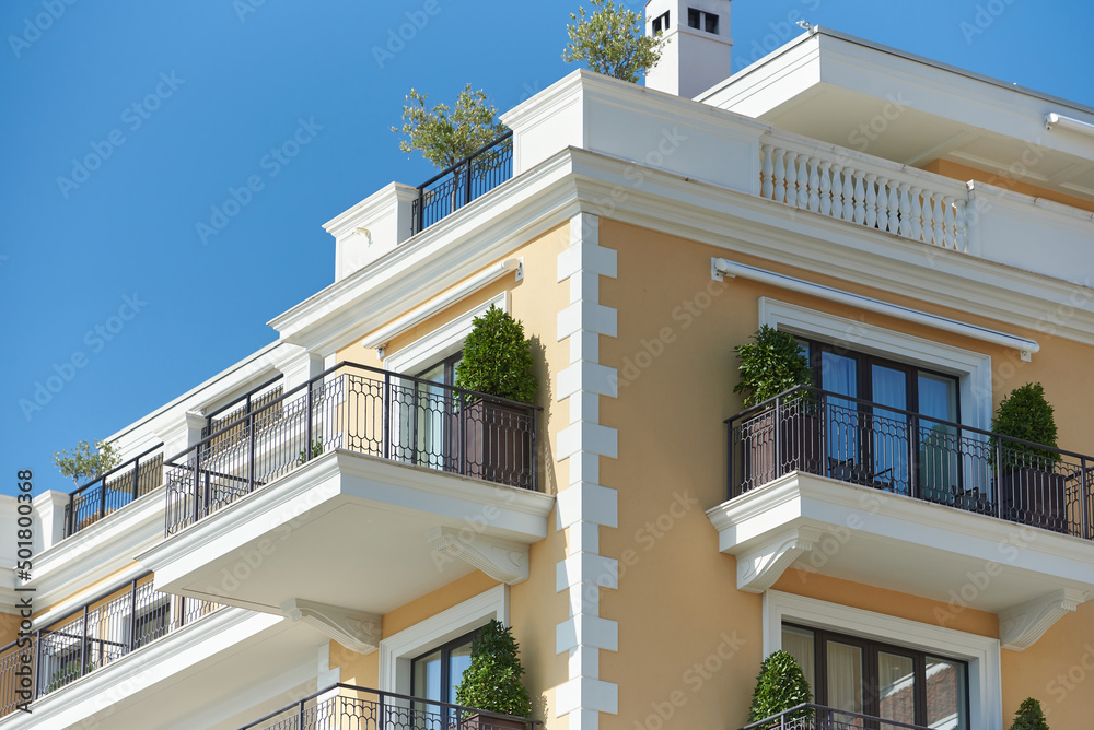 Luxury apartment building with balconies and green plants