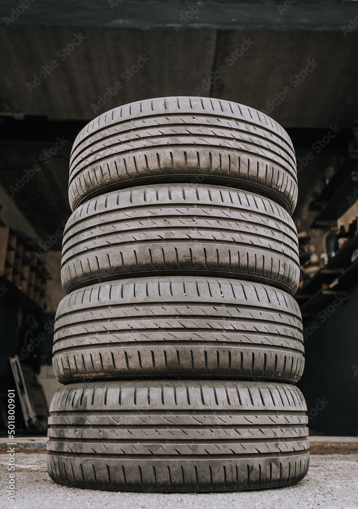 Obraz premium Four summer rubber tires from the wheel are in the tire shop for replacement.