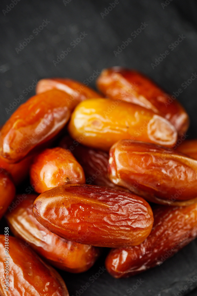 juicy royal dates on a black wooden rustic background juicy royal dates on a black wooden rustic background