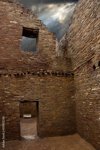 Chaco Canyon ruins with dramatic stormy sky.