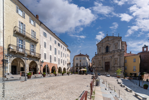 Mondovì, Italy - April 29, 2022: Piazza Maggiore with church of San Francesco Saverio, also called Church of the Mission (17th century), the ancient town hall building and historic buildings