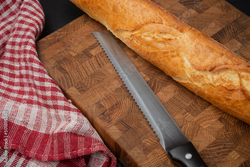 File knife for bread near the baguette photo