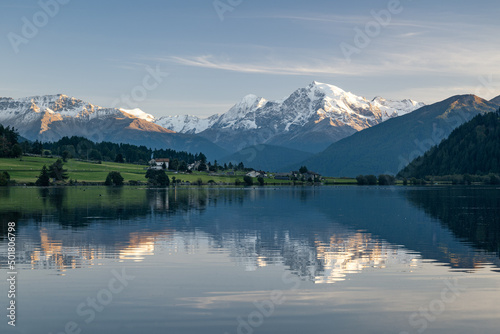 The snow-capped peak of the Ortler is reflected in the idyllic Haidersee, South Tyrol, Italy, Europe
