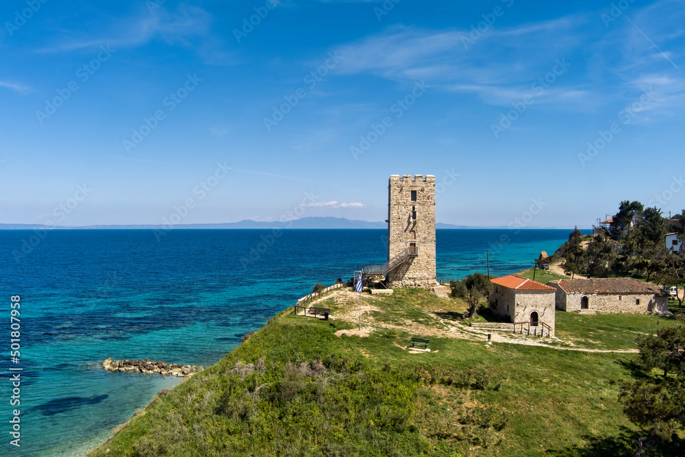 Aerial view of  byzantine tower and beach of village Nea Fokea in Chalkidiki Greece