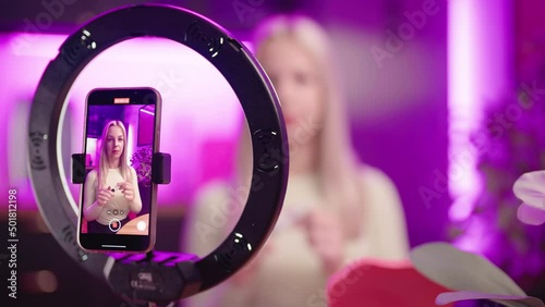 Female make up influencer record eyelashes care tutorial with smartphone 4K