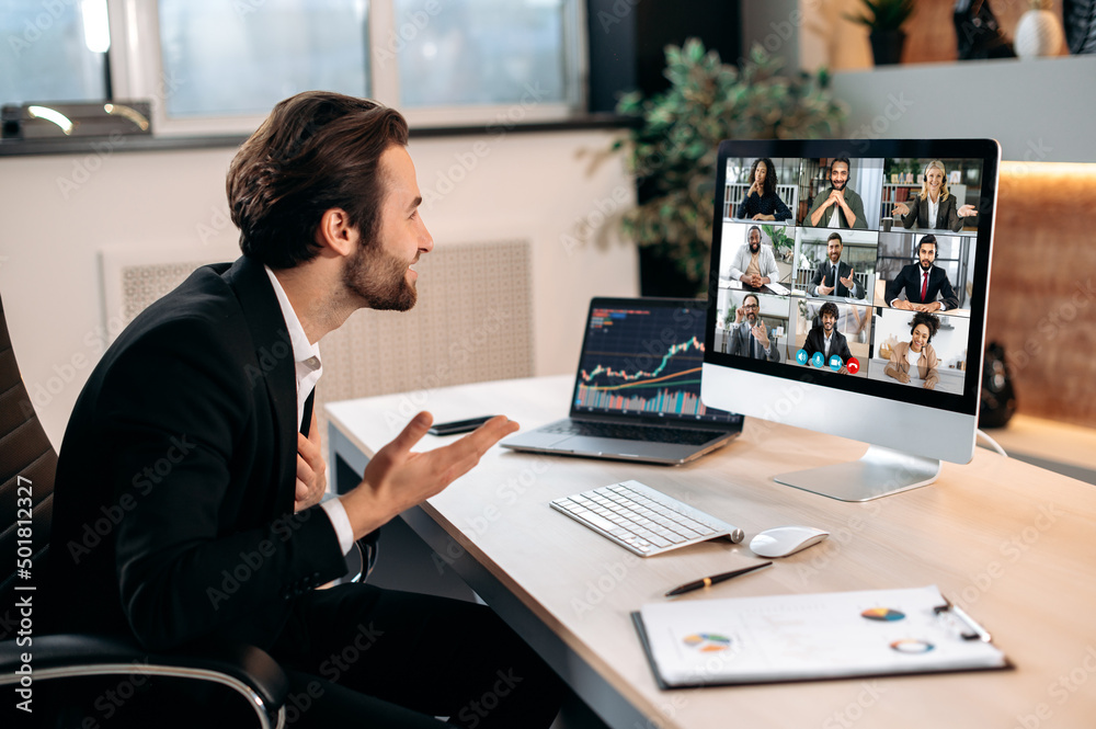 Group brainstorm by video call. Successful caucasian male stock broker sits in his modern office, talking by a video conference with colleagues, working out a crypto strategy, discussing risks Group brainstorm by video call. Successful caucasian male stock broker sits in his modern office, talking by a video conference with colleagues, working out a crypto strategy, discussing risks