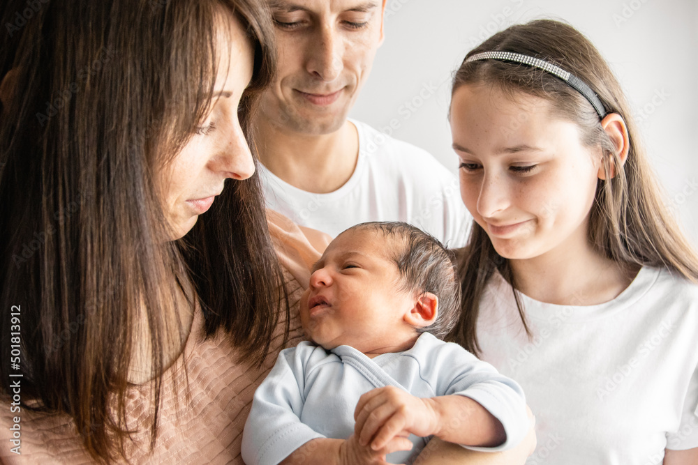 joyful family in the apartment in the daylight. Newborn baby. joyful family in the apartment in the daylight. Newborn baby.