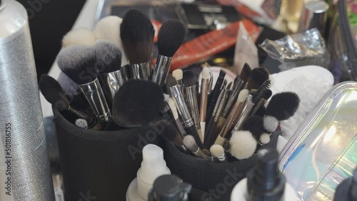 Cosmetic makeup brushes on vanity black furniture contemporary home small cups mirror interior design home decor