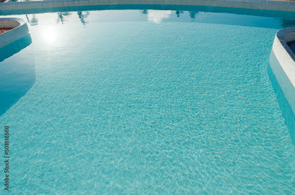 An inviting bright blue swimming pool with clear water ripple texture