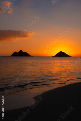 sunrise over the mokulua islands in hawaii