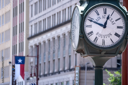 Roman Numerals Clock with Texas Flag in Background in Downtown Houston photo