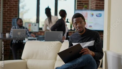 Wallpaper Mural Portrait of company employee working on laptop computer, using online technology to create financial strategy for business development. Office worker at work on couch. Handheld shot. Torontodigital.ca