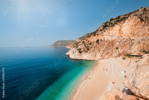 Fototapeta Naklejka Na Ścianę i Meble -  Kaputas beach in the middle of the day. Calm view of Kaputaş beach on a hot day. The most famous salils of Antalya. Turkey