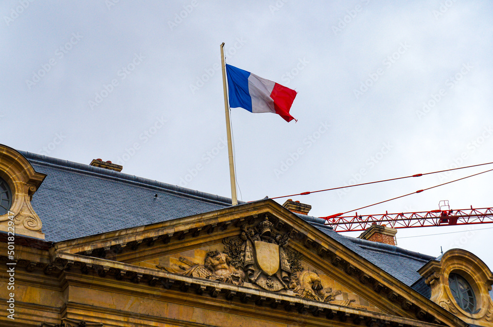 French Flag Flying on a Historic Building in Paris